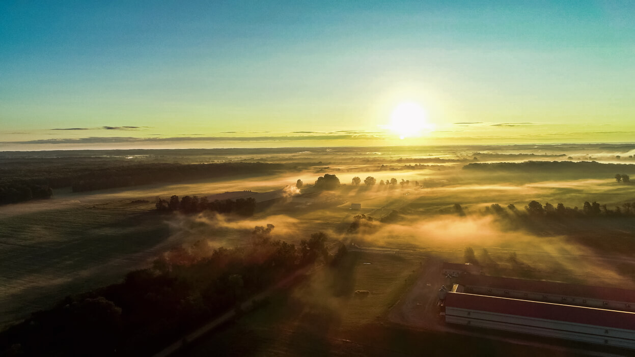 Sun appearing over clouds.